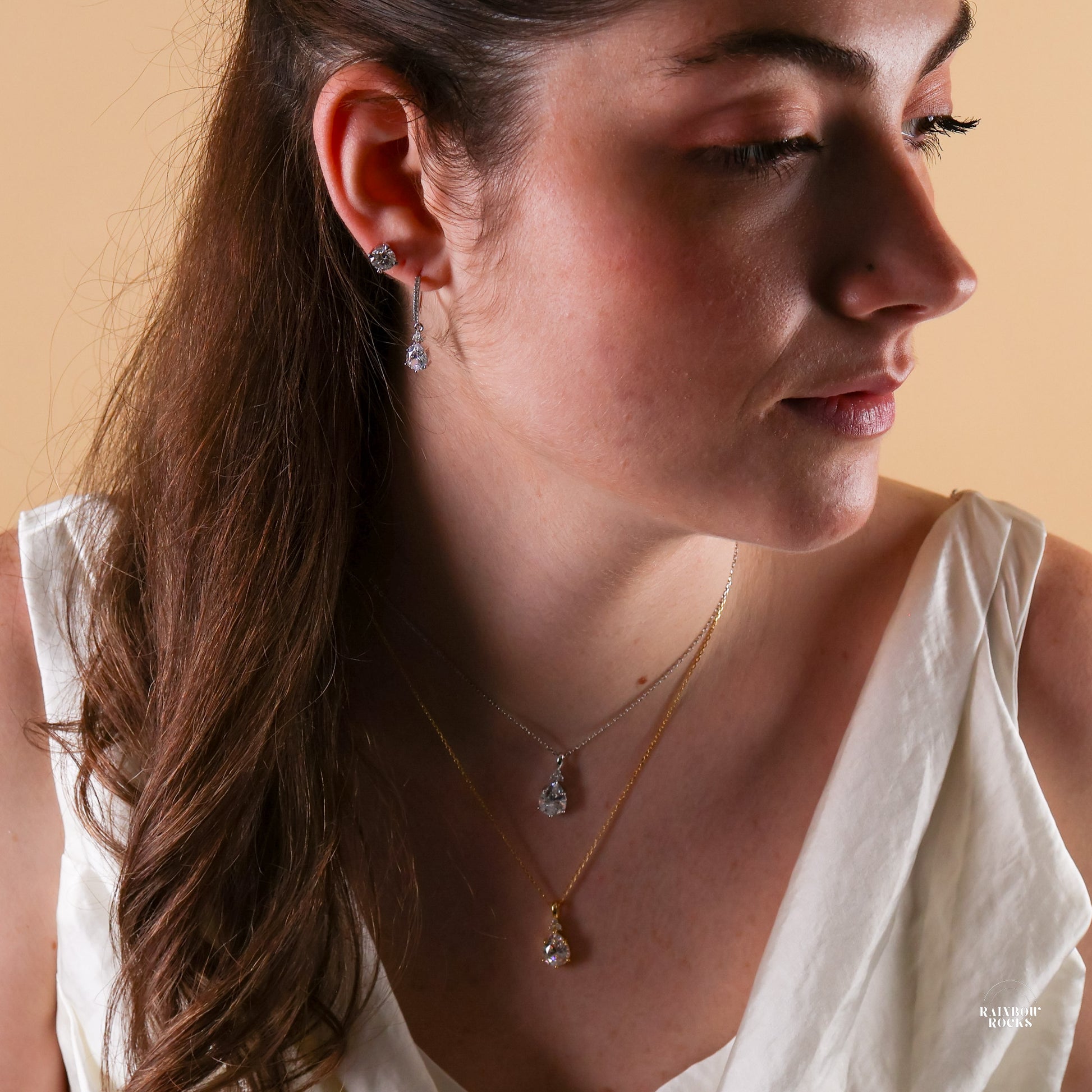 model wearing Diamond Cz Hoop Earrings 14K Gold Vermeil along with matching necklace in gold and silver