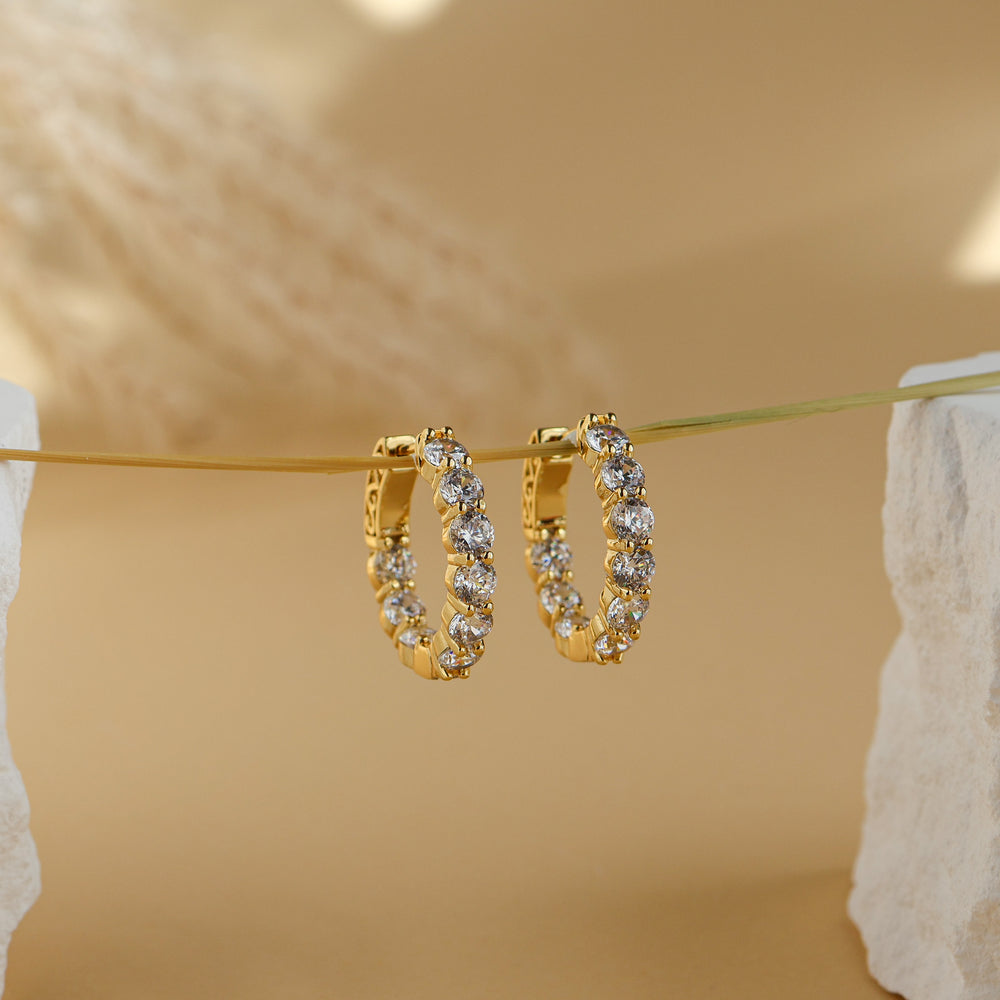 Thea eternity hoop earrings in 18K gold plate, medium hoops set with round white cubic zirconia, hanging on a gold wire