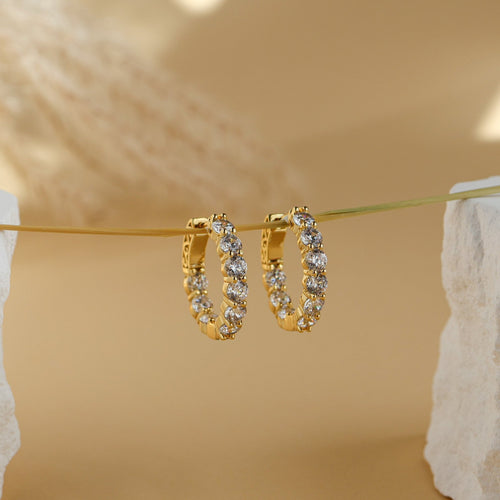 Thea eternity hoop earrings in 18K gold plate, medium hoops set with round white cubic zirconia, hanging on a gold wire