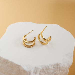 Pair of Maia double-row pave huggie hoops on a white stone - Rainbow Rocks