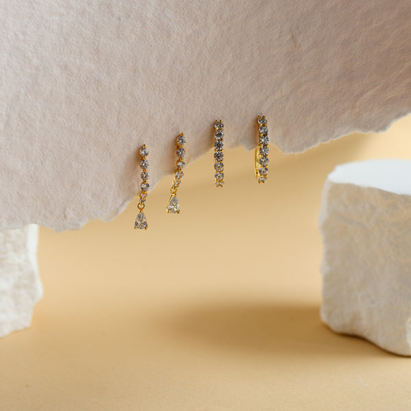 Carina gold J-hoop earrings with a single line of seven white cubic zirconia - Rainbow Rocks