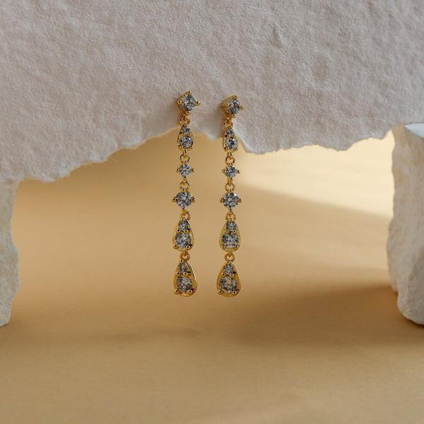 Soleil gold drop earrings close up, linked pear and round white CZ stones - Rainbow Rocks