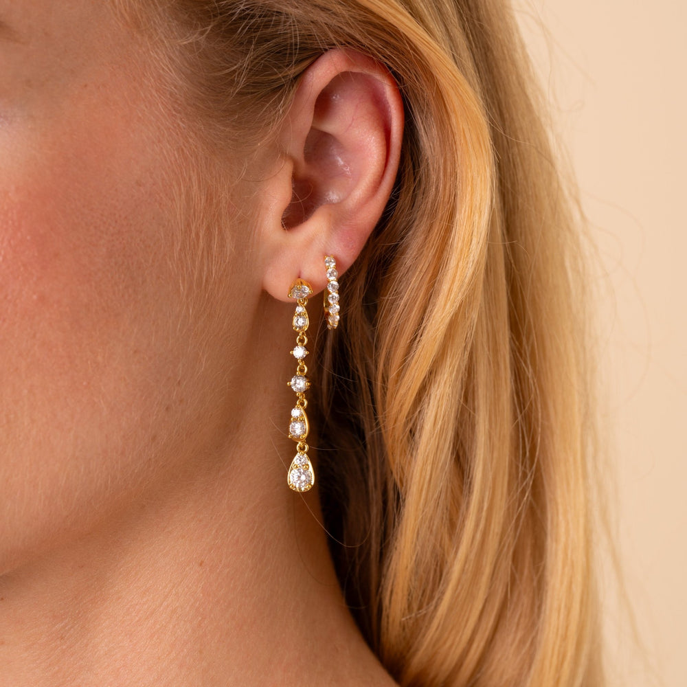 Model wearing the Soleil long CZ drop earring with the Carina CZ J-hoop in a second piercing, 18K gold plated - Rainbow Rocks