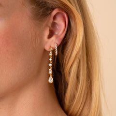 Model wearing the Soleil long CZ drop earring with the Carina CZ J-hoop in a second piercing, 18K gold plated - Rainbow Rocks