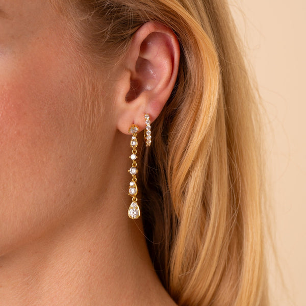 Model wearing the Soleil long CZ drop earring with the Carina CZ J-hoop in a second piercing, 18K gold plated - Rainbow Rocks